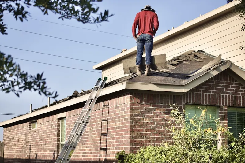 Professional roofer working on a residential roof in Ulysses